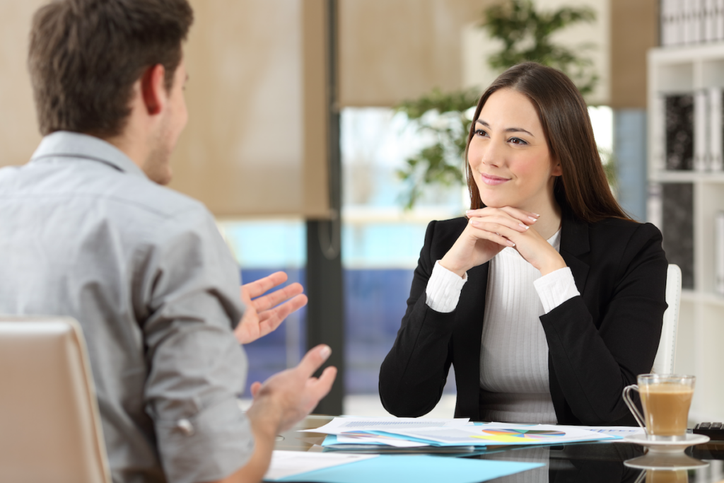 A life coach listening carefully to their client speak during a session.